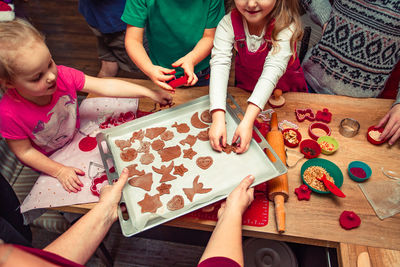High angle view of children making cookies