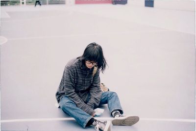 Woman looking at camera while sitting on table