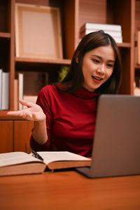 Young woman using laptop at table