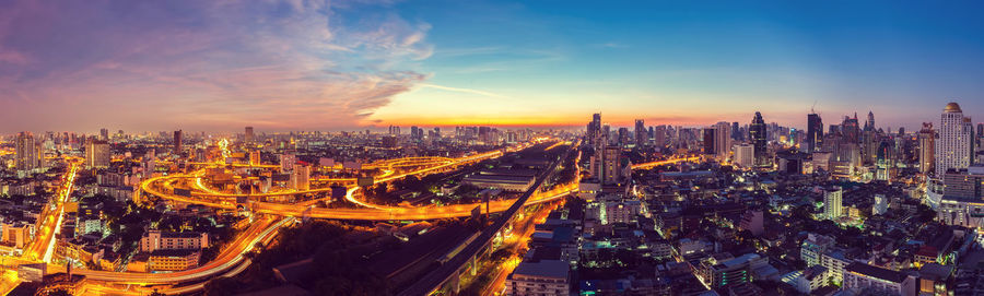 High angle view of illuminated city against sky