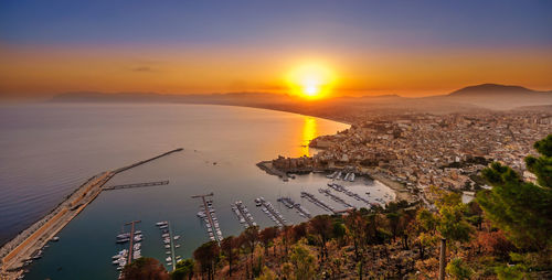 High angle view of city at sunset