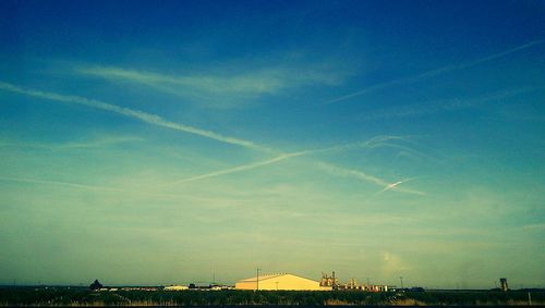 Scenic view of landscape against blue sky