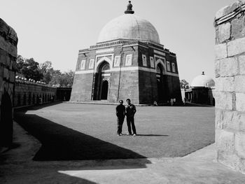 People walking in front of historical building