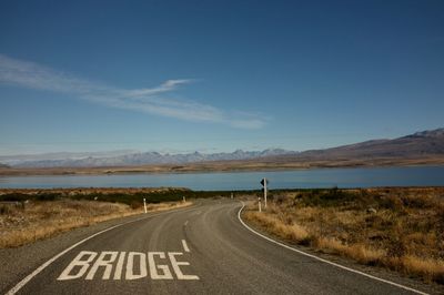 Road by landscape against sky