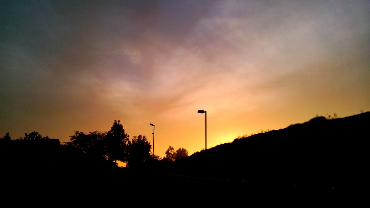 sunset, silhouette, sky, beauty in nature, orange color, tranquility, tranquil scene, scenics, tree, nature, landscape, idyllic, dark, street light, cloud - sky, sun, outline, cloud, outdoors, field