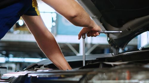 Low section of man cleaning car