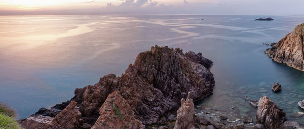 Panoramic view of rock formation in sea against sky