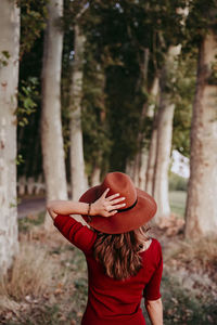 Rear view of woman wearing hat standing outdoors