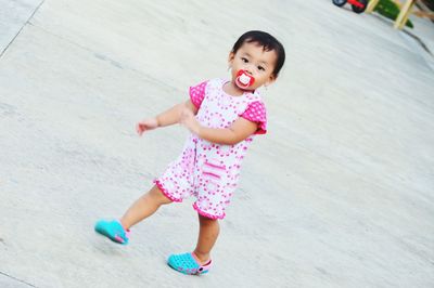 High angle view of girl running on pink face