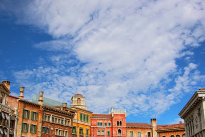 Low angle view of building against cloudy sky