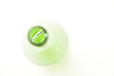 Close-up of green spoon against white background