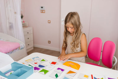 Lifestyle of a smart girl playing a logic game at home. the concept of board games for children