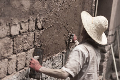 Rear view of a mason at work