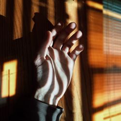 Close-up of hand on window at home