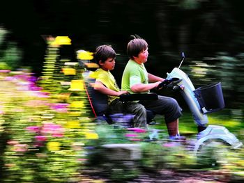 Blurred motion of men riding motorcycle