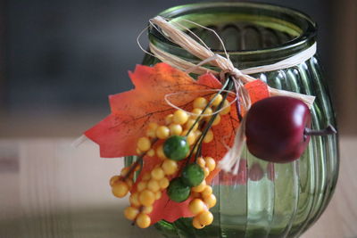 Close-up of multi colored candies in glass jar on table