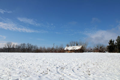 Snow covered field against sky