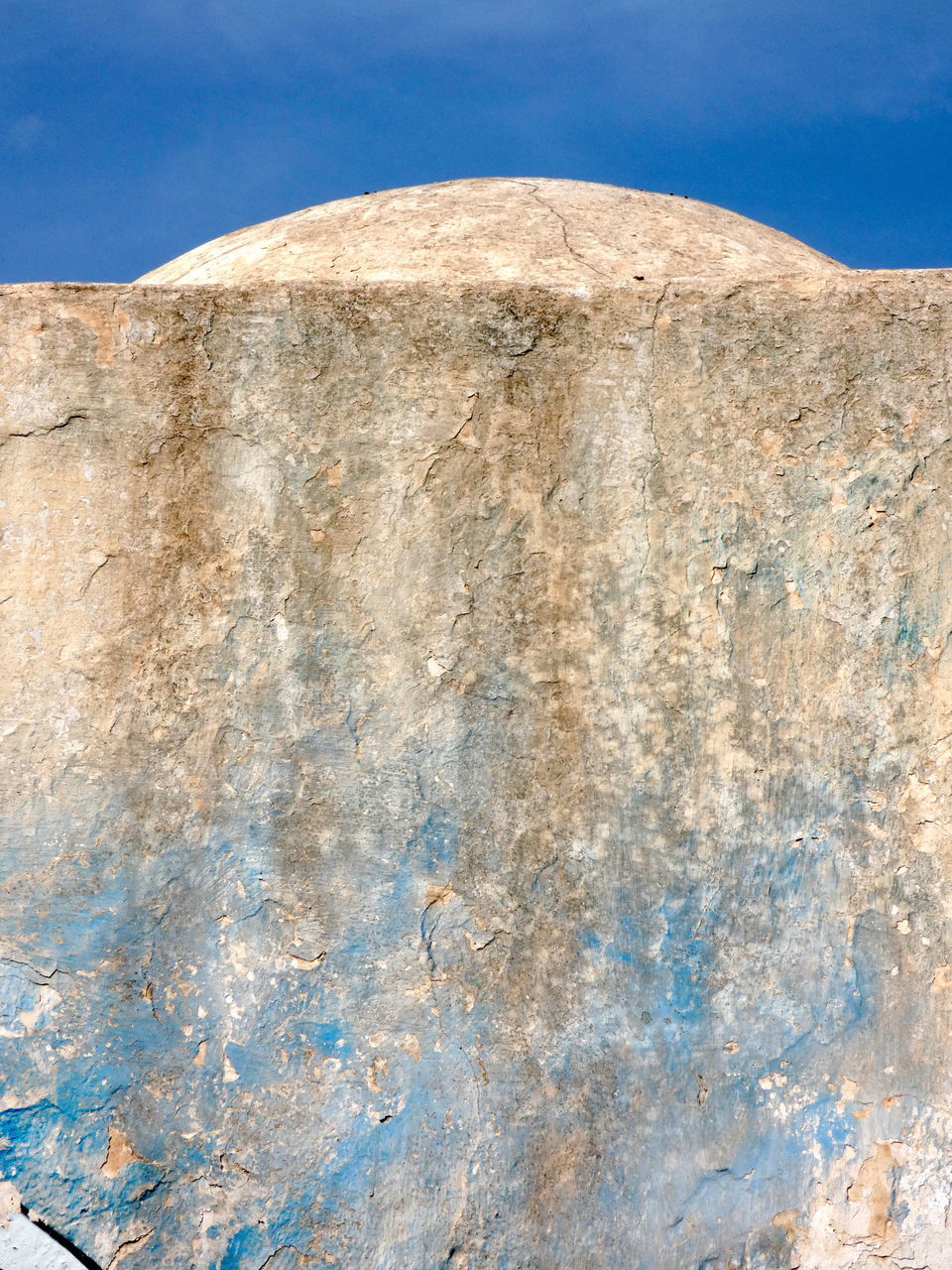 LOW ANGLE VIEW OF BLUE STONE WALL