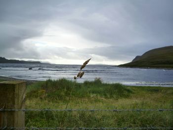 Scenic view of sea against cloudy sky