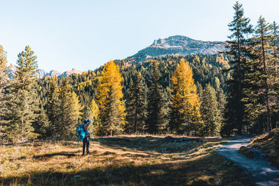 Rear view of woman on mountain against sky