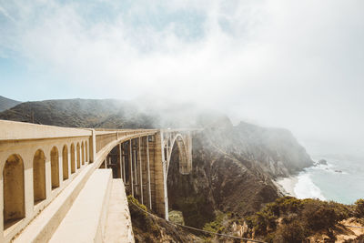 Bixby creek bridge on mountain against sky