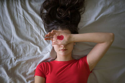 Close-up of child hand on bed