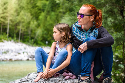 Woman with baby sitting in water