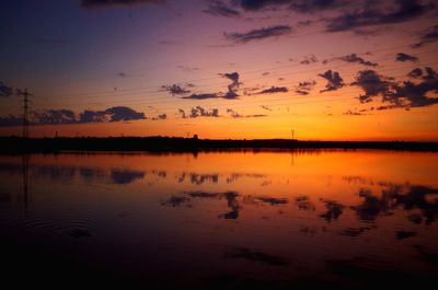 Scenic view of lake against romantic sky at sunset