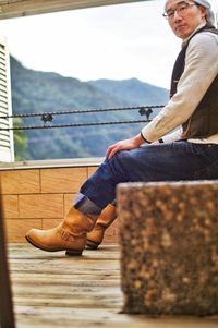 Low section of man sitting on staircase