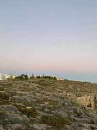 Scenic view of landscape against clear sky during sunset