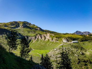Scenic view of mountains against clear blue sky