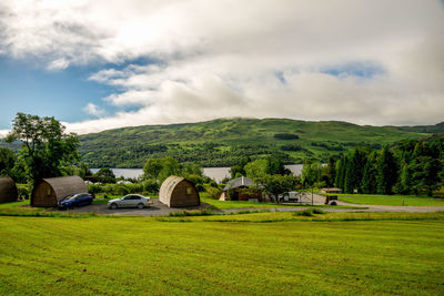 Houses on field against sky