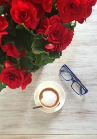 Close-up of red flower on wooden table