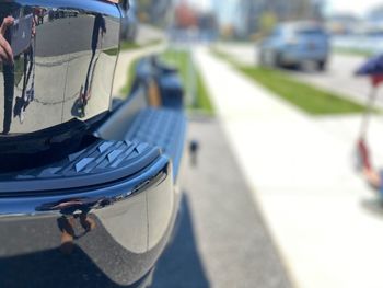 Close-up of vehicles on road