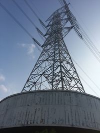 Low angle view of silhouette electricity pylon against sky