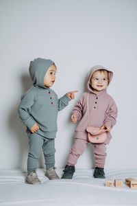 Baby fashion. unisex gender neutral clothes for babies. two cute baby girls or boys in cotton set