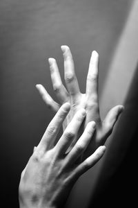 Close-up of hands against gray background