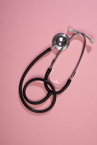 High angle view of eyeglasses on street against pink background