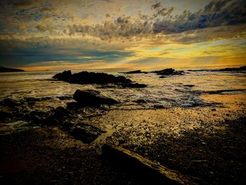 Close-up of low angle view of sea at sunset