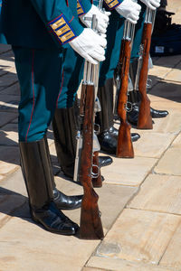 Low section of soldiers standing on footpath