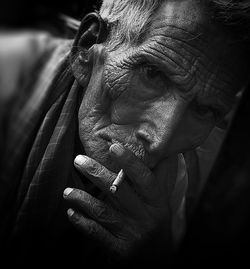 Close-up portrait of man smoking cigarette