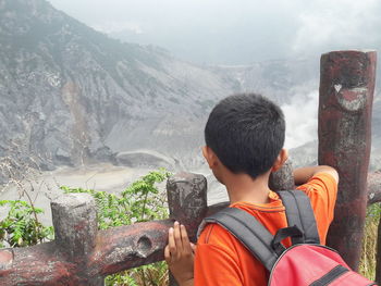 Rear view of man looking at mountains