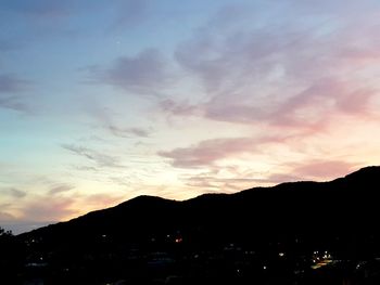 Scenic view of silhouette mountains against sky at sunset