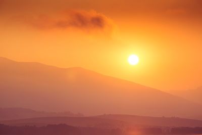 A beautiful sunrise over the lake with mountains in distance. morning landscape in warm tones.