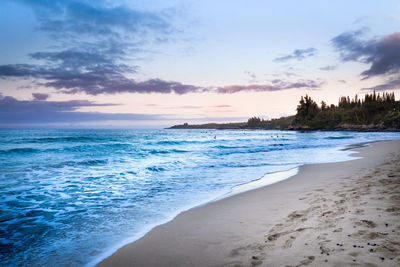 Scenic view of beach against sky during sunset