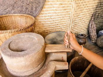 Close-up of woman holding traditional grinder 