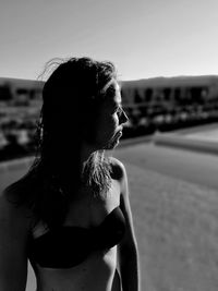 Woman wearing bikini top looking away