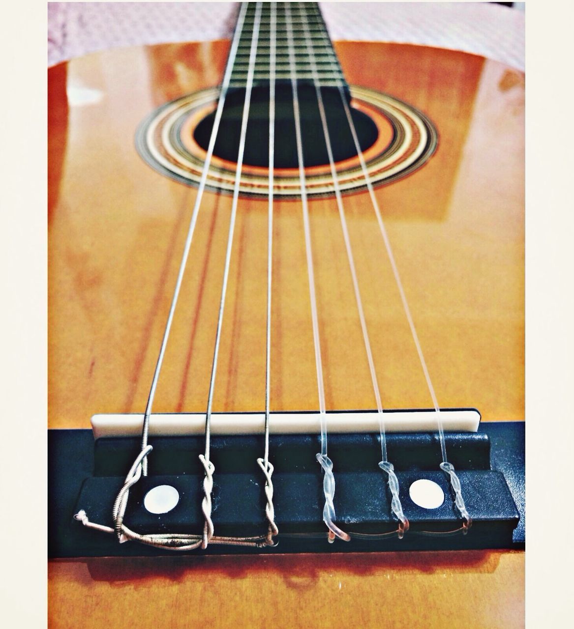 indoors, music, musical instrument, high angle view, guitar, arts culture and entertainment, still life, musical equipment, musical instrument string, technology, table, close-up, metal, string instrument, acoustic guitar, no people, directly above, equipment, piano key, wood - material