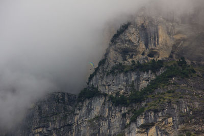 Low angle view of cliff against sky