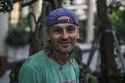 Portrait of man wearing cap while standing outdoors